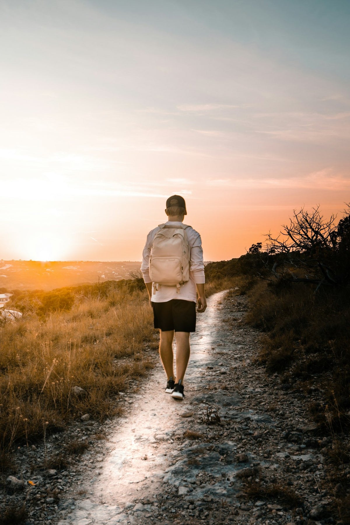 A man hiking a limestone trail at sunset