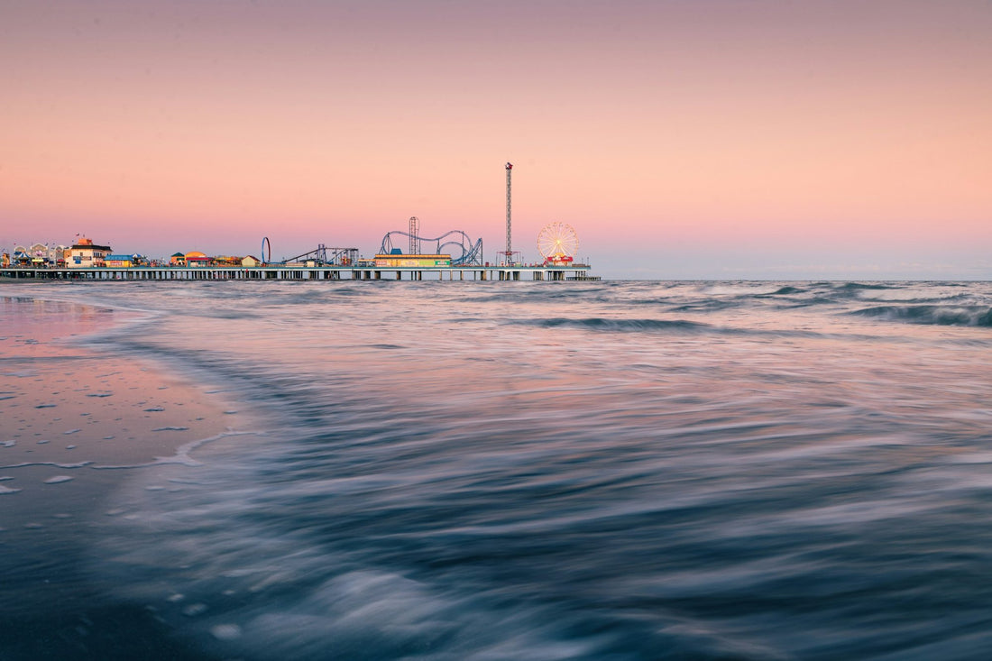 The Galveston pier at sunset over the Gulf