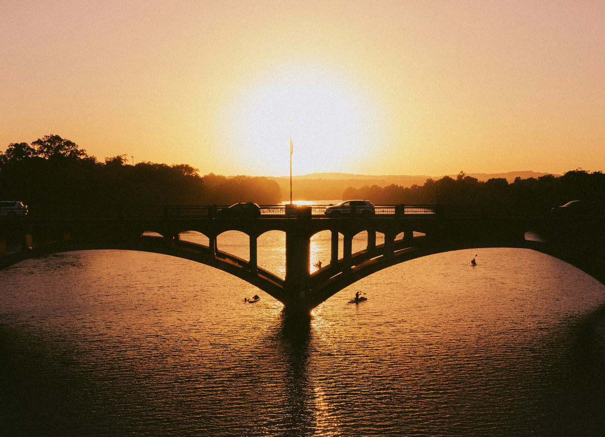 Paddlers on Lady Bird Lake at sunset in Austin