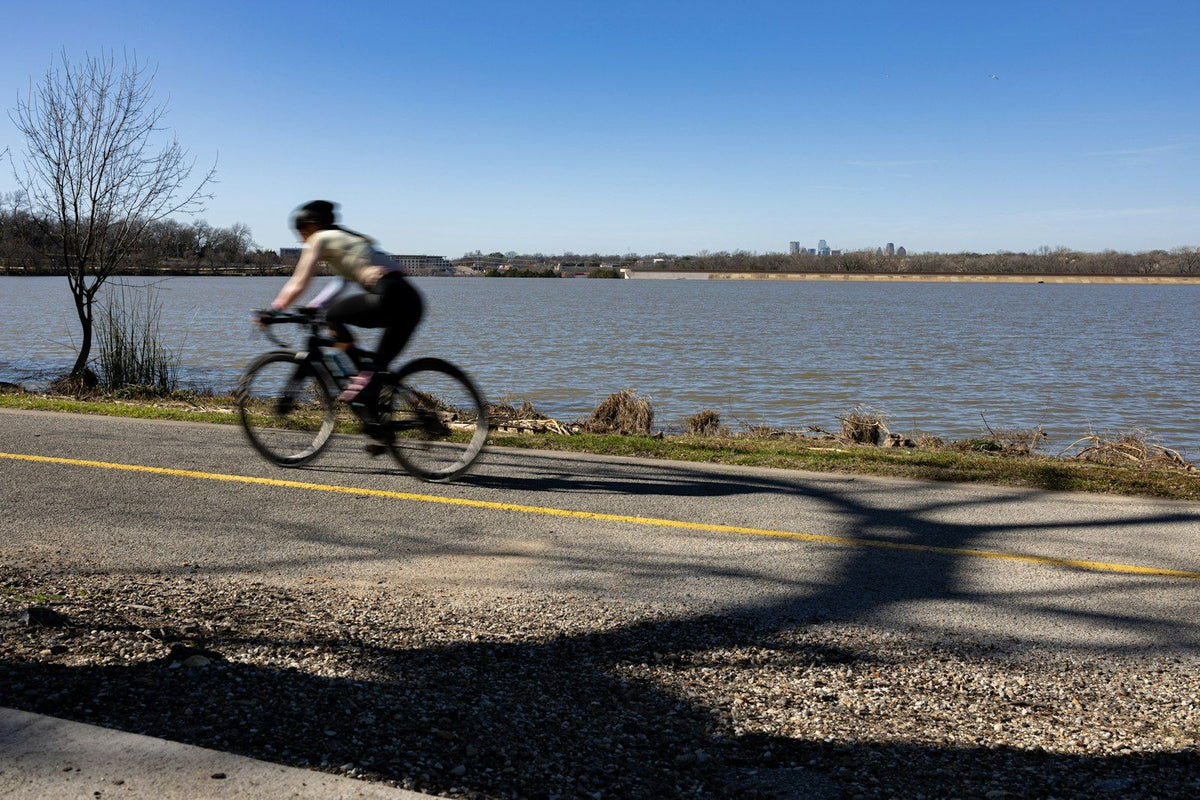 A cyclist riding the trail around White Rock Lake in Dallas